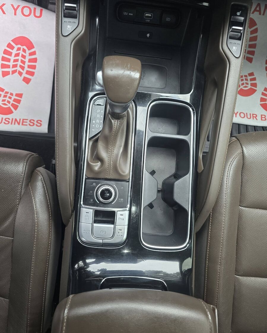 The same center console cleaned out, with fresh paper mats laid in the footwells