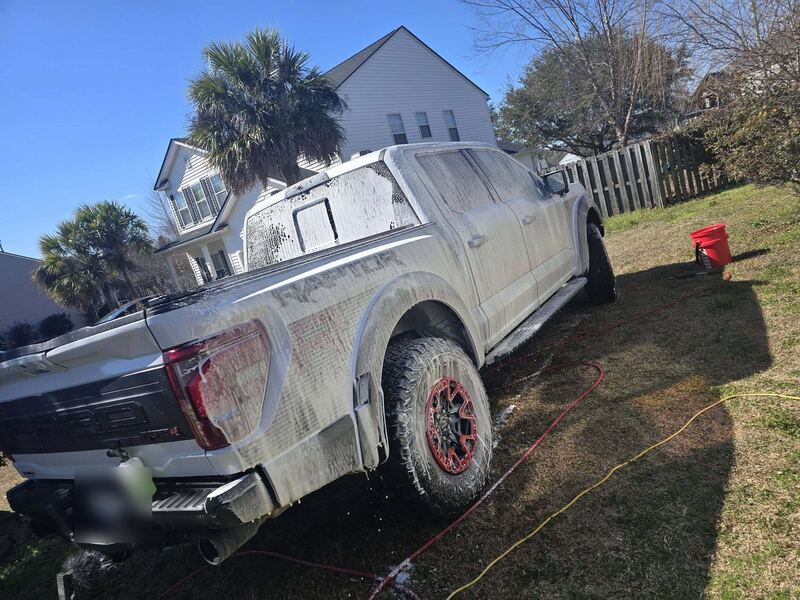 Full-size pickup under foam during an exterior wash